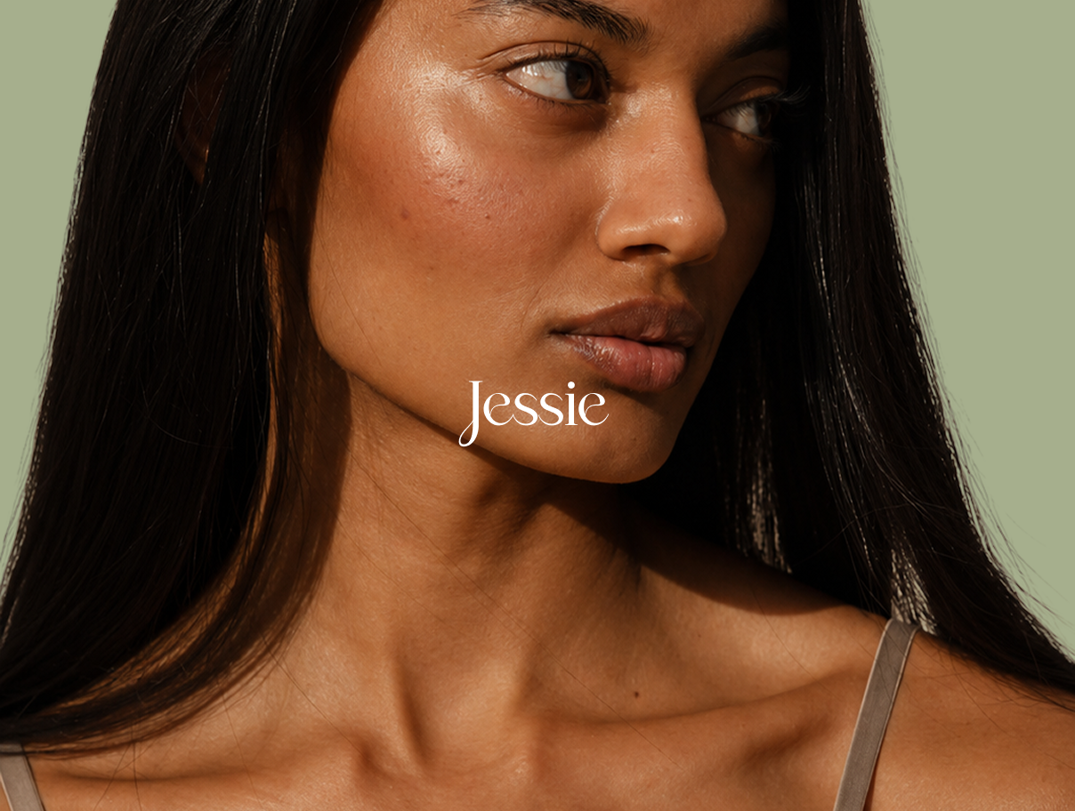 Close-up portrait of a woman with long dark hair against a sage-green background, labeled “Jessie.”
